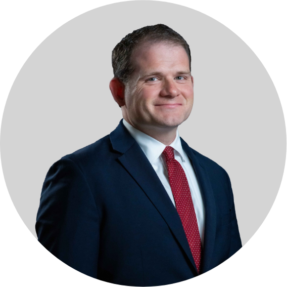 Adam Murka wears a suit in progessional headshot